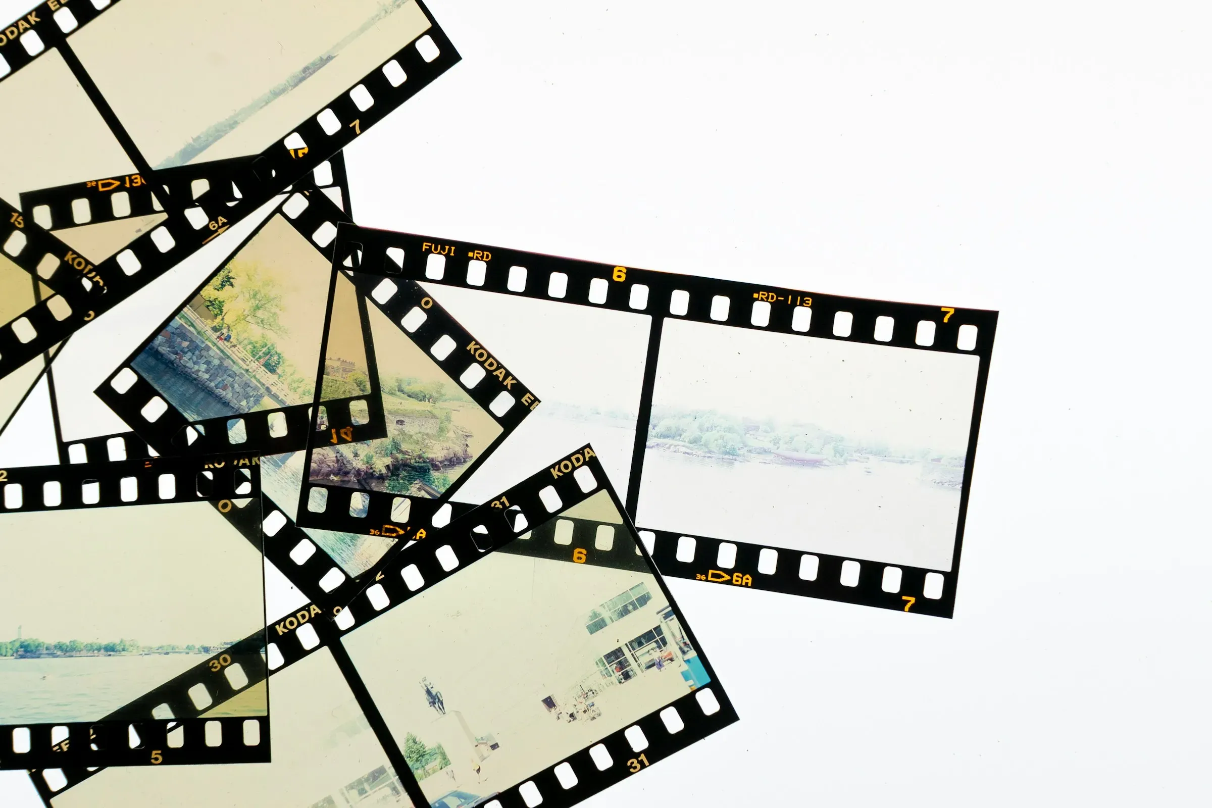 Thirty-five millimetre strips scattered on a light table, one frame still empty.